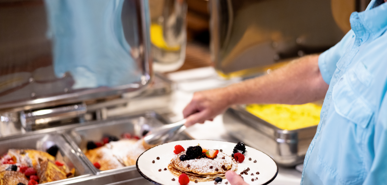 someone enjoying pancakes with fresh fruit at horseshoe bay resort
