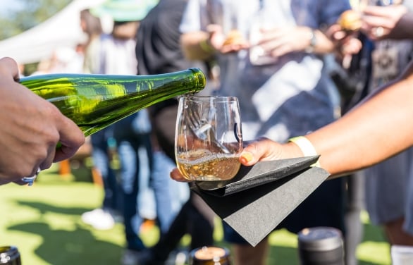 glass of wine being poured at the wine, dine, and jazz festival at horseshoe bay resort