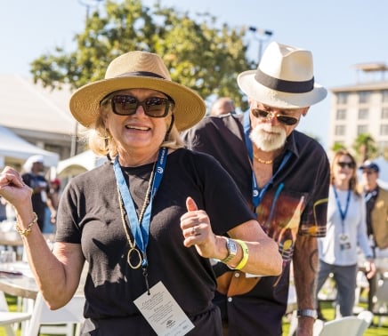 a man and woman dancing at the wine & amp jazz festival at horseshoe bay resort in 2024