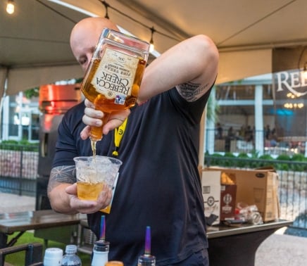 Man pouring Rebecca Creek Whiskey