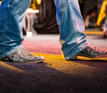 cowboy boots walking on stage